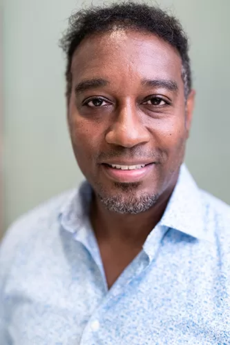 Image of a man wearing polo wearing a beautiful smile