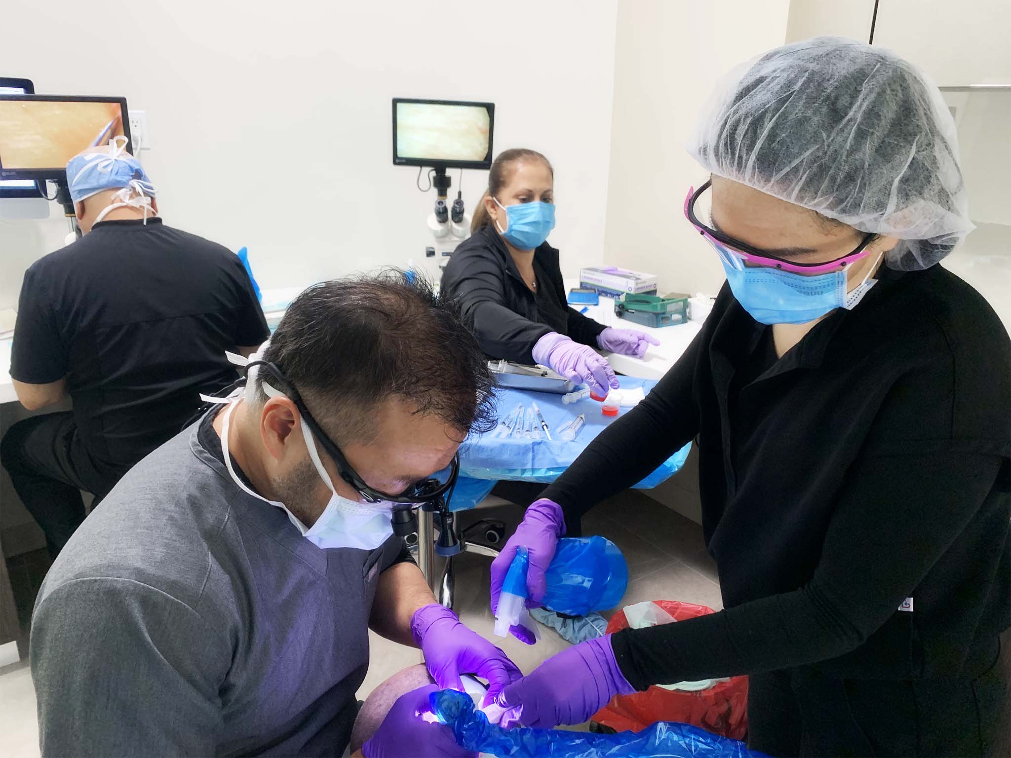 A picture of a team Jae Pak MD doing a surgery on a patient